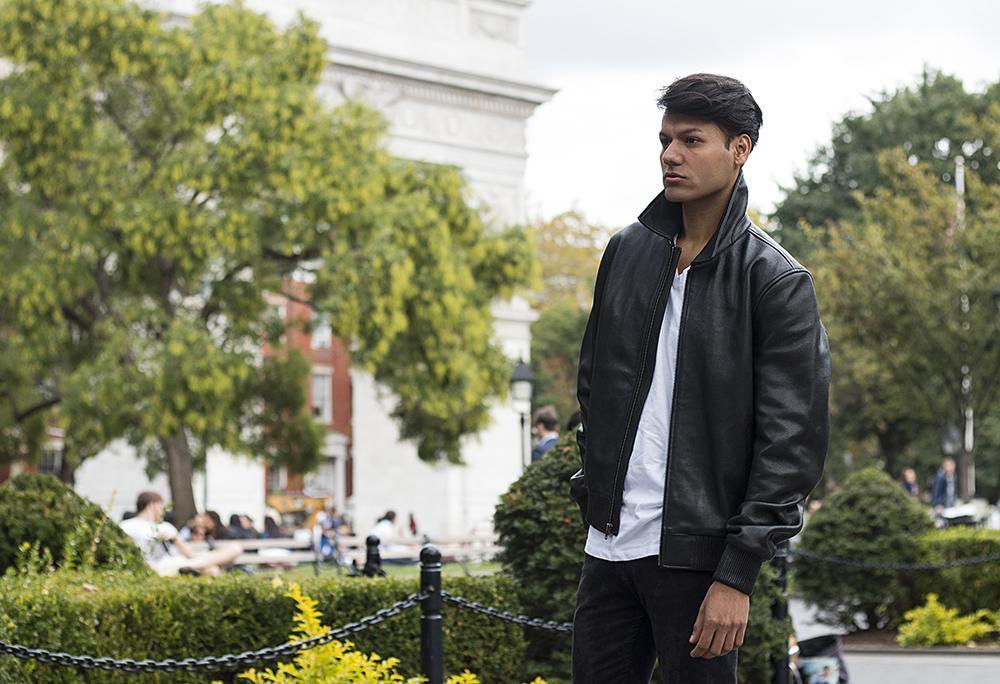 A model wearing the Castor Leather Bomber Jacket, demonstrating its timeless, understated style and comfortable fit