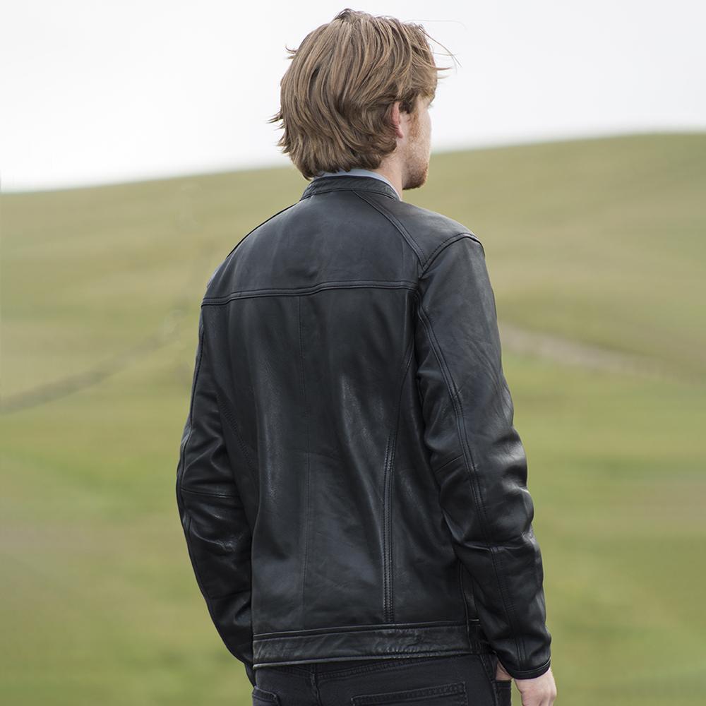 A model wearing the Iconoclast Leather Jacket in whiskey, illustrating its timeless appeal and refined craftsmanship